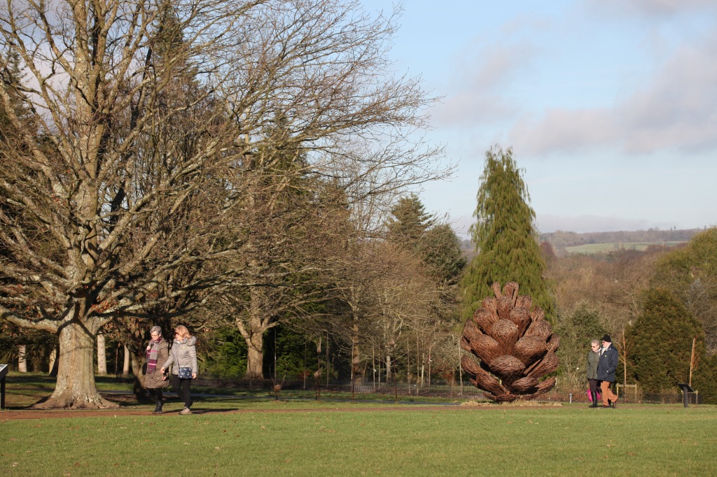 Walkers and pine cone sculpture
