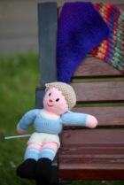 Knitted boy on bench