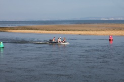 Boat going through buoys